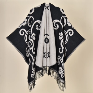 Detailed view of the vintage floral pattern and tassel hem on the reversible shawl