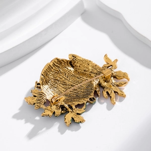 Golden metal pumpkin corn brooch back view featuring secure pin clasp and textured finish
