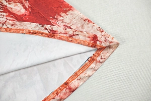 Macro detail of elastic marble print fabric with professional orange overlock stitching