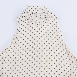 Flat lay of elegant beige polka dot halter neck dress in lightweight chiffon fabric