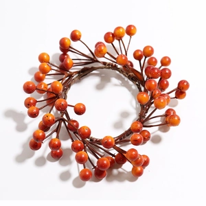Close-up of orange berries candle ring for autumn and Thanksgiving home table decor