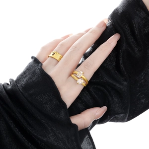 Dual-layer hollow gold ring set with diamonds on a model with black mesh sleeve