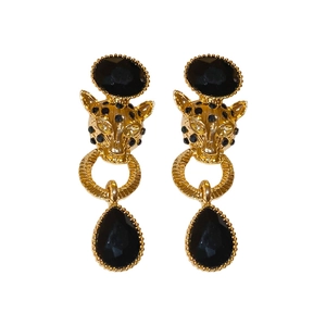 Vintage golden leopard head earrings with black rhinestones and crystals on white background