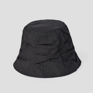 Detail showing the natural fiber texture and pleated design of a black linen bucket hat