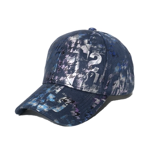 Dark blue tie-dye baseball cap with metallic graffiti print and 45-degree angle view