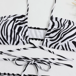 Detailed close-up of zebra stripe bikini top with halter neck ties and ruched fabric texture