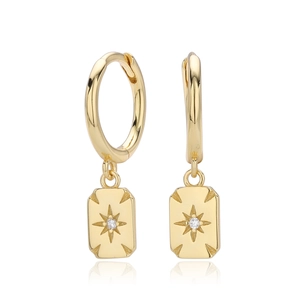 Macro detail of gold S925 sterling silver drop earrings with zircon star pendants