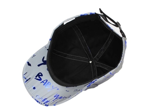 Detail of grey baseball cap showing blue metallic print and adjustable back strap