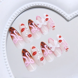 Leopard print stiletto press-on nails with 3D bows and pearls on heart mirror tray