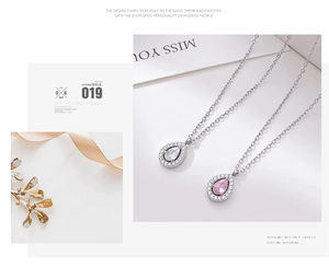 Macro detail of tear-drop crystal pendants with sparkling zircon halo on silver chains