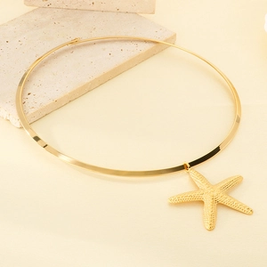 Detailed view of a gold starfish pendant on a polished stainless steel metal neck collar