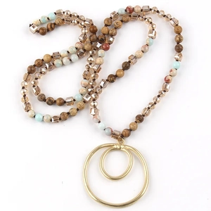 Macro shot of multi-colored beaded necklace with golden double circle pendant detail