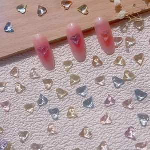 3D transparent heart-shaped charms on gradient pink manicure nails with crystal decor