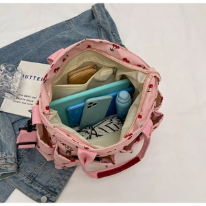 Detail view of pink cherry tote bag interior showing large capacity for tablet and phone