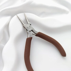 Macro detail of jewelry round nose pliers with brown non-slip handle for DIY wire looping