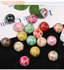 Macro detail of acrylic beads with snowflake prints for Christmas DIY jewelry making