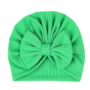 Detail of green ribbed fabric and large bow on this elastic infant turban hat