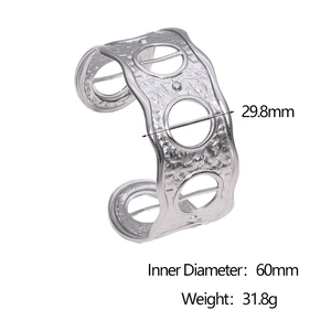 Detail of silver hammered texture cuff bracelet with geometric circular cut-outs