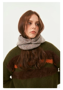 Detail of colorful speckled knit balaclava neck warmer paired with a striped winter sweater
