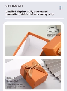 Detail of square orange gift box with brown velvet bow and premium corner craft texture