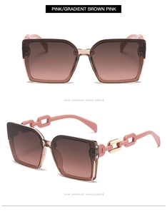 Detail of pink square sunglasses featuring stylish golden chain design on the temples