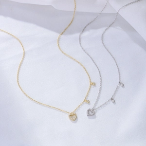 Detail of S925 sterling silver hollow heart necklace with paved white crystals