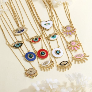 Detailed close-up of colorful Evil Eye heart and round pendants with zircon and enamel stones