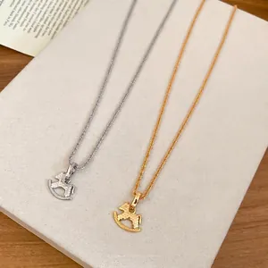 Gold and silver rocking horse pendant necklaces with shimmering honeycomb textures