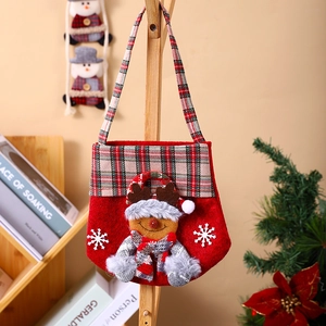 Close-up of a plaid Christmas gift bag with a 3D cartoon figure hanging on a wooden hanger