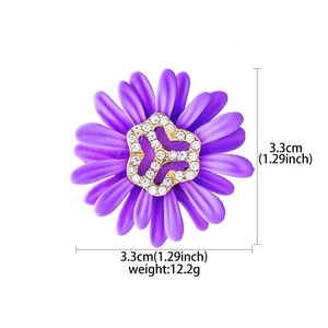 Detailed view of purple daisy brooch with white rhinestones measuring 3.3cm by 3.3cm