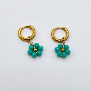 Handmade gold flower drop earrings with green faceted crystal beads and steel hoops
