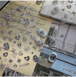 Close-up of retro silver embossed heart and star nail stickers with application effects