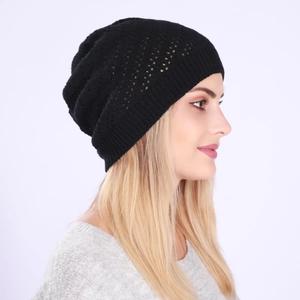 Detail view of the black knit beanie showing the hollow crochet texture and ribbed edge