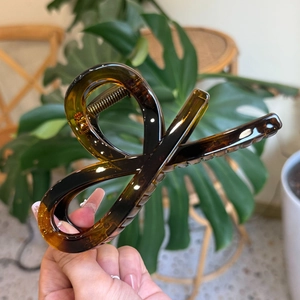 Close-up of deep amber tortoiseshell resin hair claw clip with durable metal spring