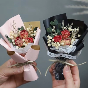 Mini dried rose bouquets in pink and black packaging with Best Wishes sticker labels