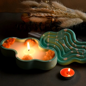 Cloud-shaped candle holder with wavy texture lid and burning floral floating candles