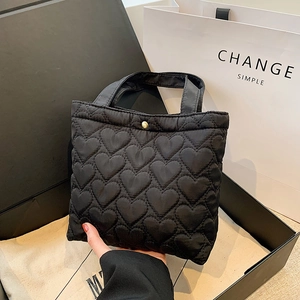 Minimalist black heart quilted oxford tote bag with gold buckle and top handle design