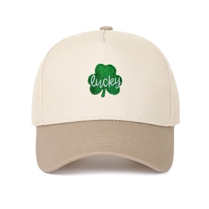 Close-up of green shamrock embroidery and lucky text on two-tone trucker baseball cap