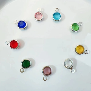Macro view of assorted colorful round crystal pendants with gold-plated metal edges for DIY