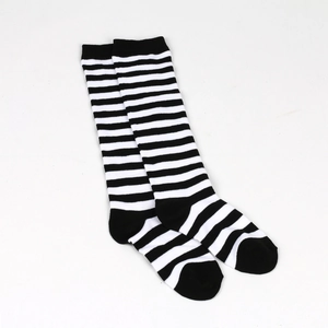 Detail shot of knitted black and white striped knee-high socks for girls' cosplay