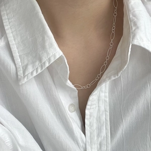 Minimalist s925 sterling silver chain necklace for women worn on a white shirt