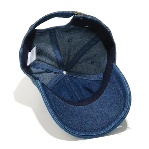 Detail showing internal structure and 100% cotton wash label of denim baseball cap