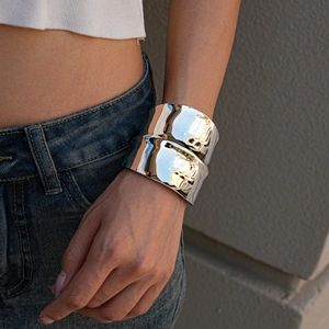 Polished silver irregular concave cuff bracelet shown on wrist for a modern metallic look