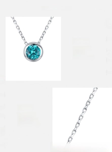 Macro detail of S925 sterling silver chain and blue zircon pendant with manual setting