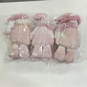 Detailed view of three pink sequined snowman dolls with height measurement scale