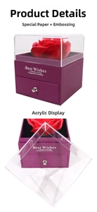 Detail view of purple jewelry box with transparent acrylic lid and red preserved rose