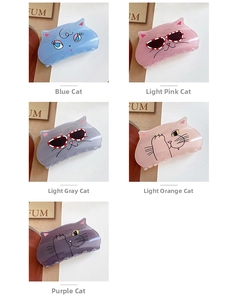 Close-up of five colorful acrylic cat hair claws in blue pink gray orange and purple