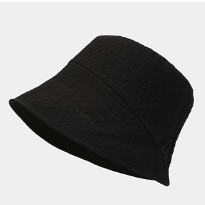 Minimalist black bucket hat for women with textured fabric and structured wide brim design