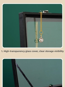 Detail view of dustproof badge storage box with clear glass lid and black frame finish