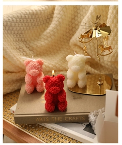 Detailed close-up of rose bear scented candles in red, pink, and white wax textures